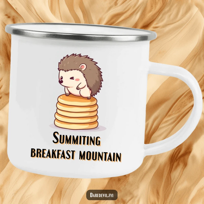 Funny hedgehog camping mug: a tiny hedgehog balancing on pancakes, sturdy for outdoor adventures.