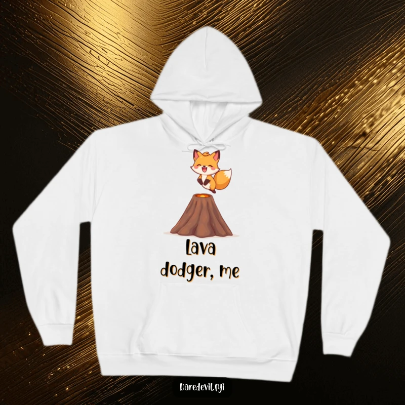 Funny fox hoodie, depicting a fox leaping over a tiny volcano with a smile, offering warmth and courage.