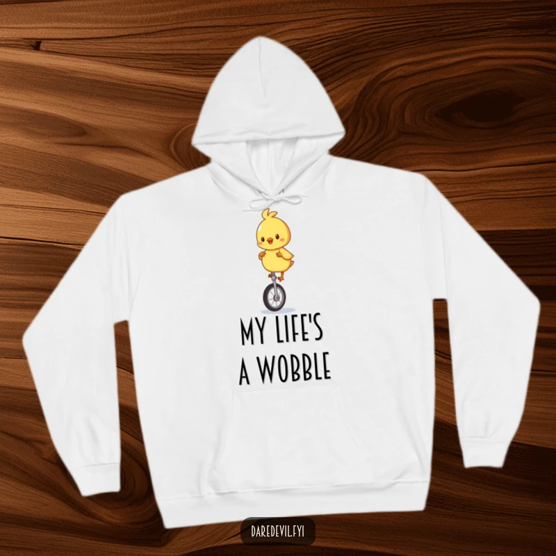 Funny hoodie designed with a playful chick character wobbling on a unicycle, offering warmth and amusement.