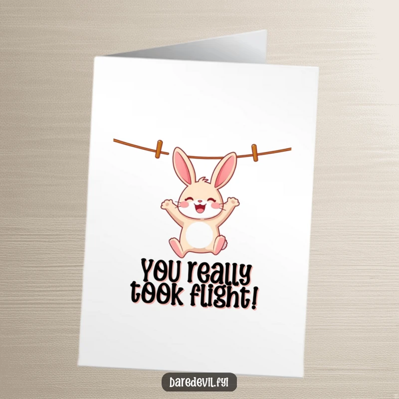 Funny Free Printable Congrats Card: Cheerful rabbit swinging on a clothesline, a humorous downloadable gift.