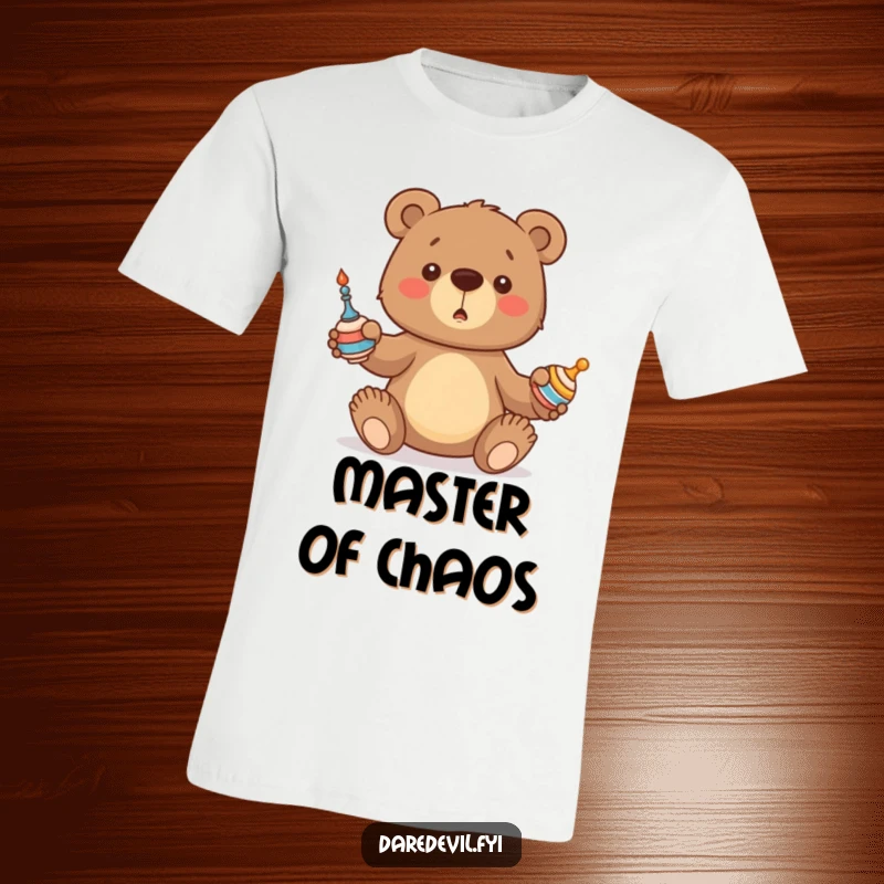 Funny Bear T-Shirt depicting a cute bear cub struggling to juggle three spinning objects, radiating endearing clumsiness and humor.